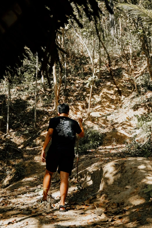 a person hiking on a dirt path through the woods