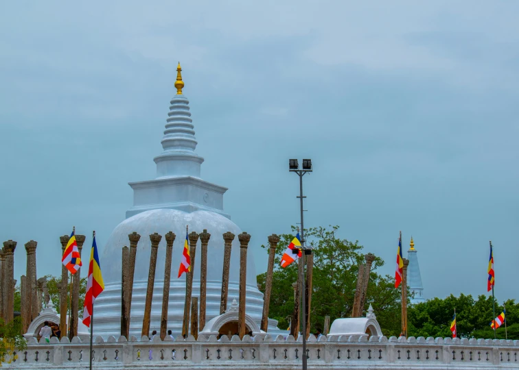 an outside structure with many flags flying in the wind