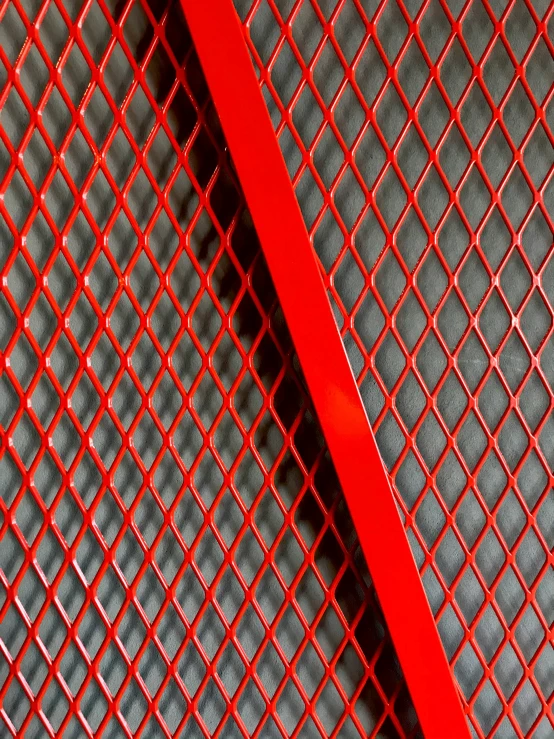 a picture of an orange metal screen with some red lines