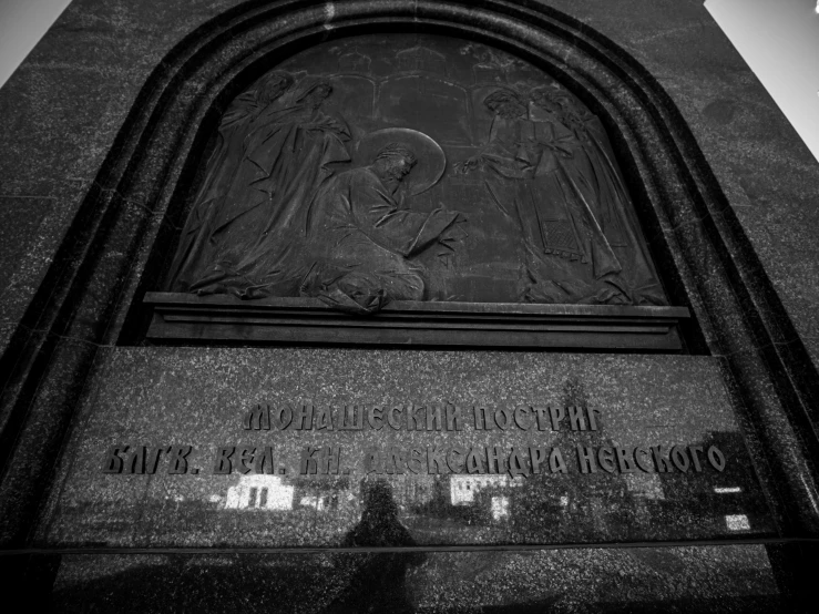 a stone monument features angels and saints