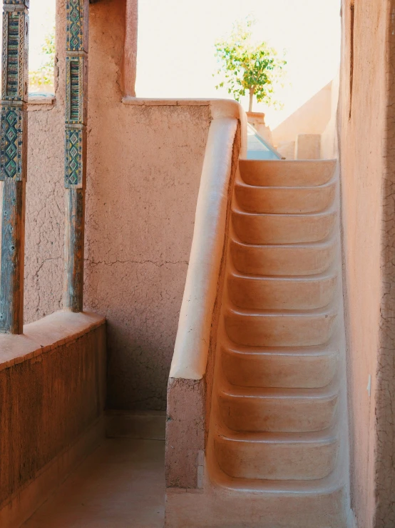 the stairs lead up to a potted plant on top of a window