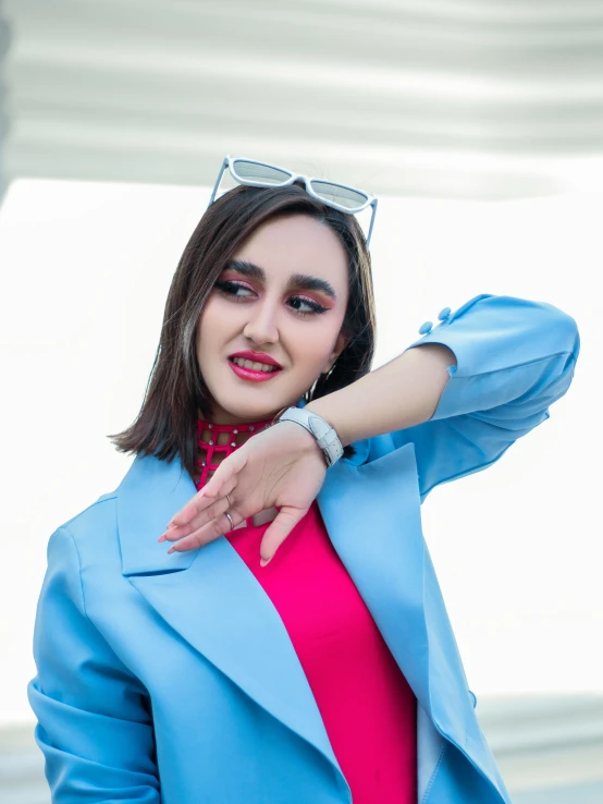 a woman with glasses on her head and pink shirt