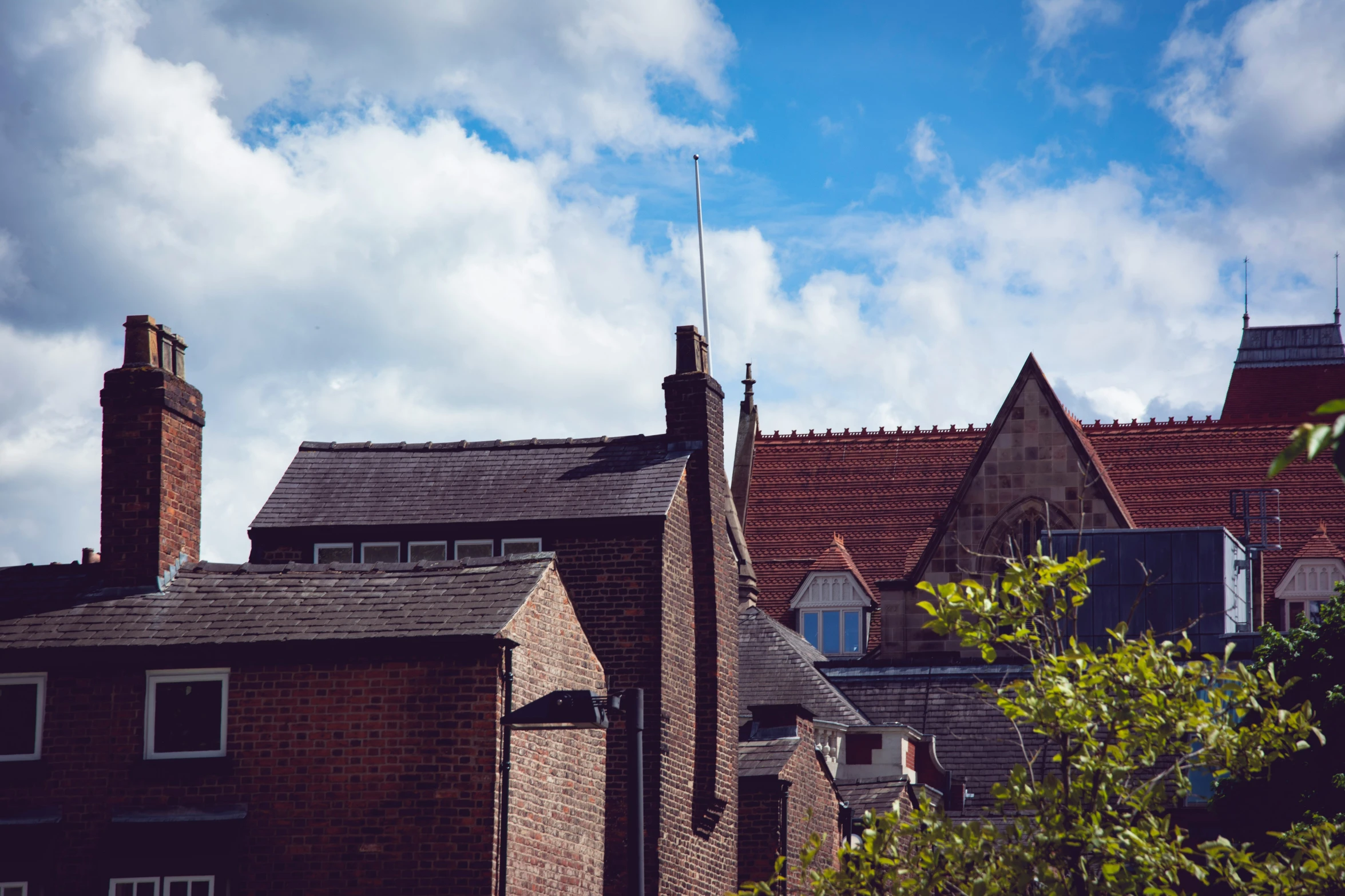 the rooftops and chimneys of two old brick houses
