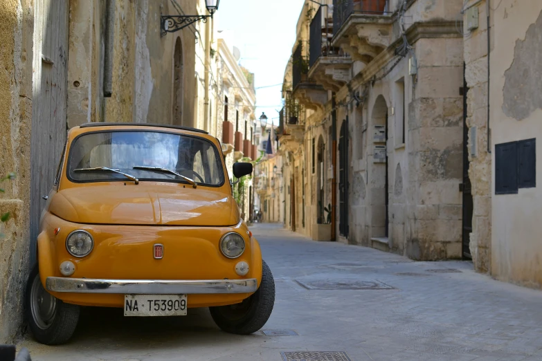 an orange car parked on the side of a street