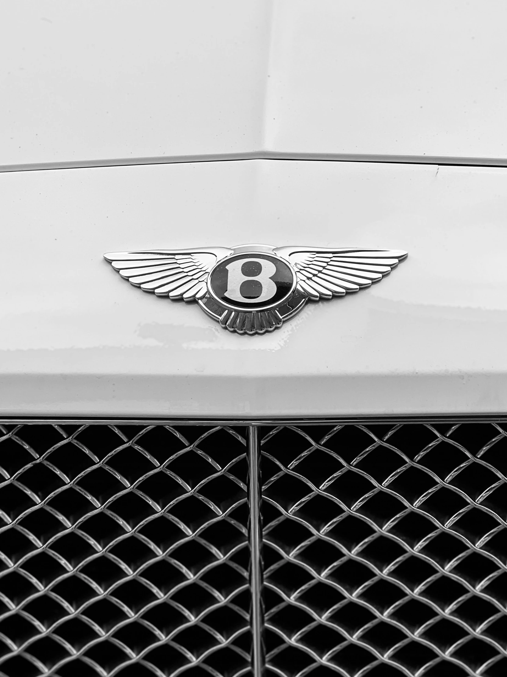 a silver car with the letter b on it