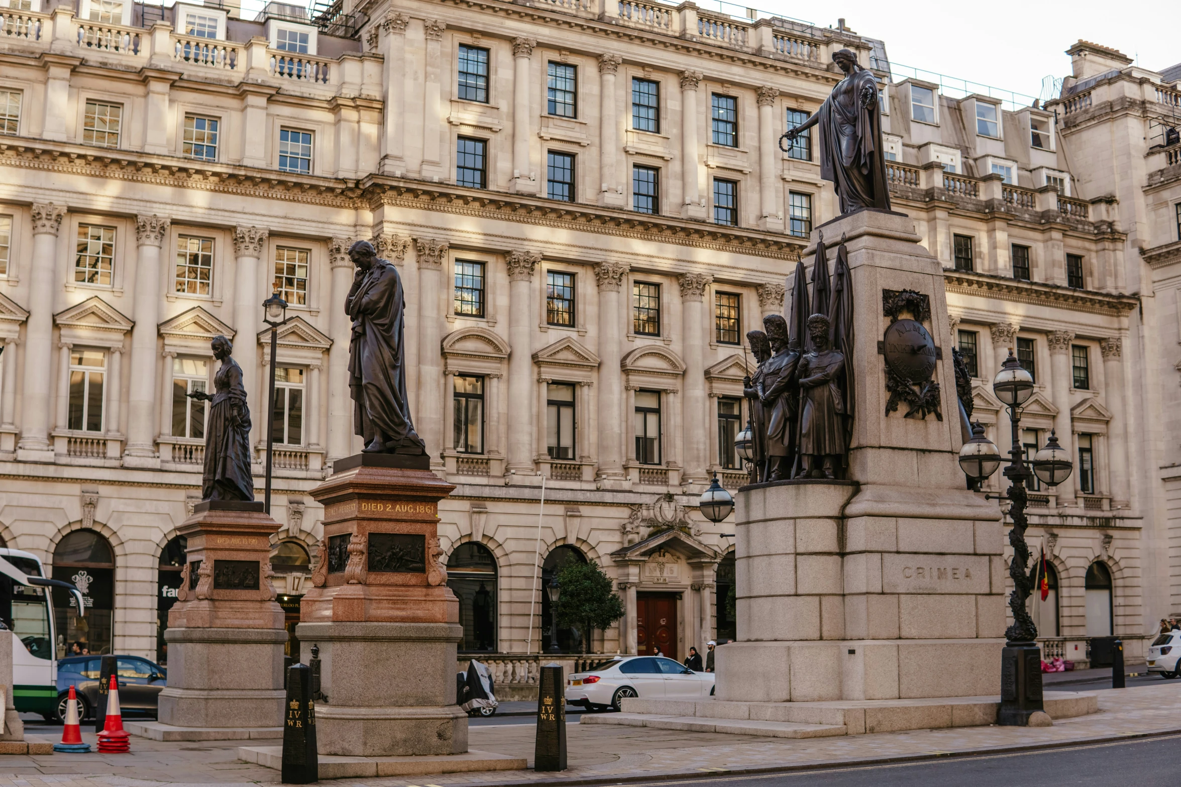 a large brown building with statues in front of it