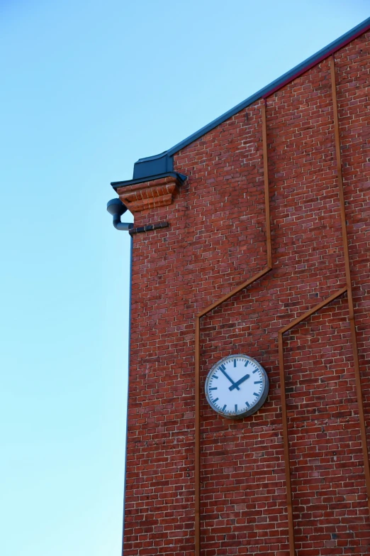 a clock sits on the side of a tall brick building