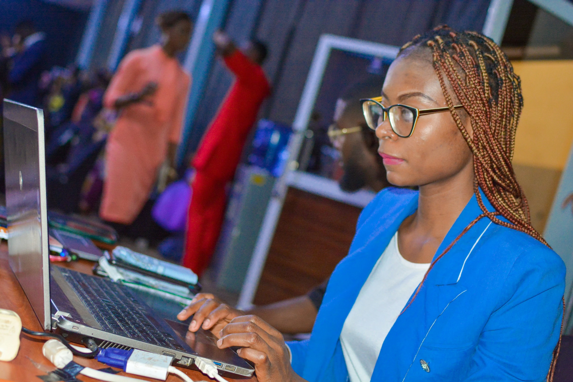 the woman uses her laptop computer on the desk