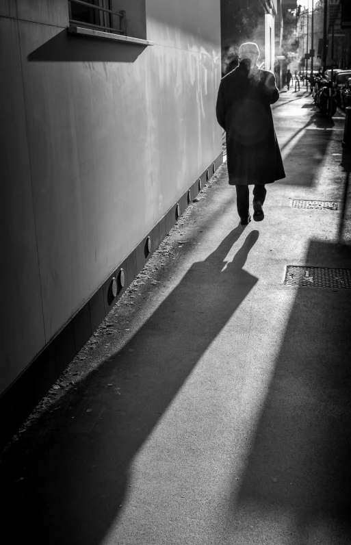 a woman walking down the street with a coat on