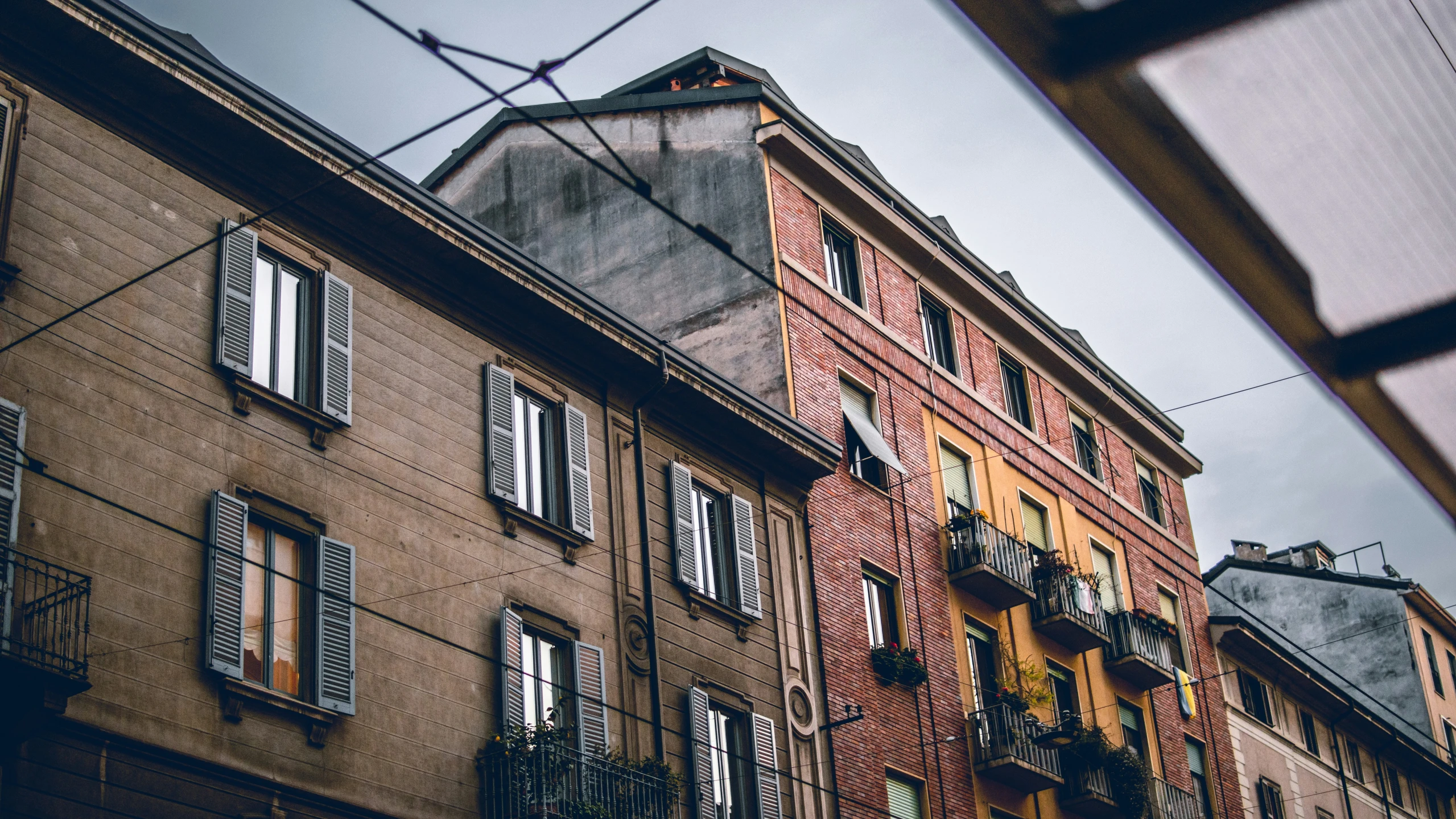 a building with several windows and iron bars