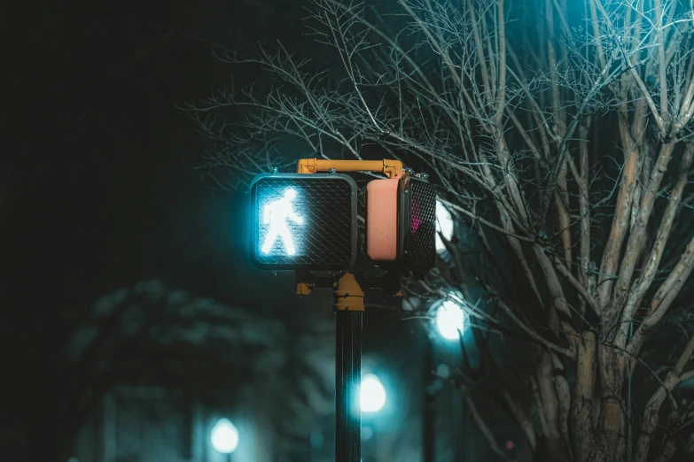 the street light is lit up on a rainy day