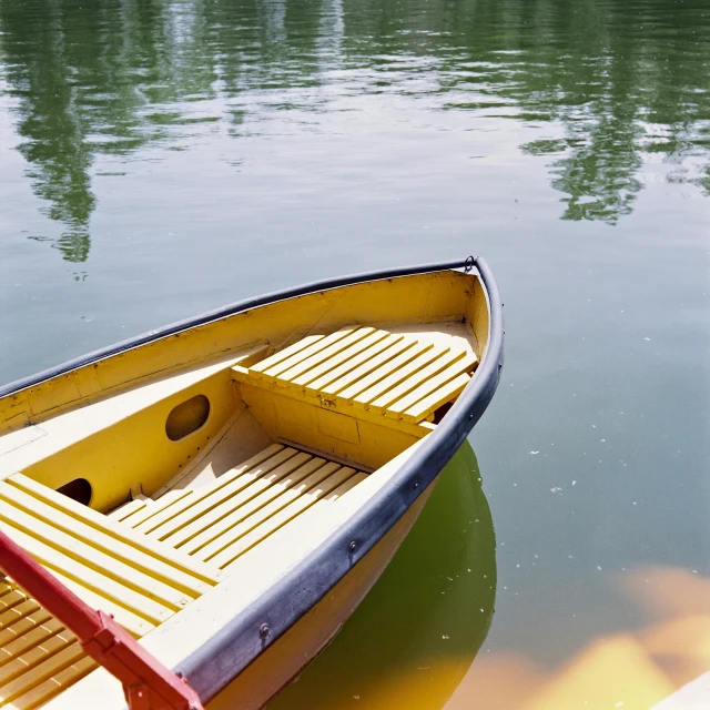 an empty row boat floating on top of the water