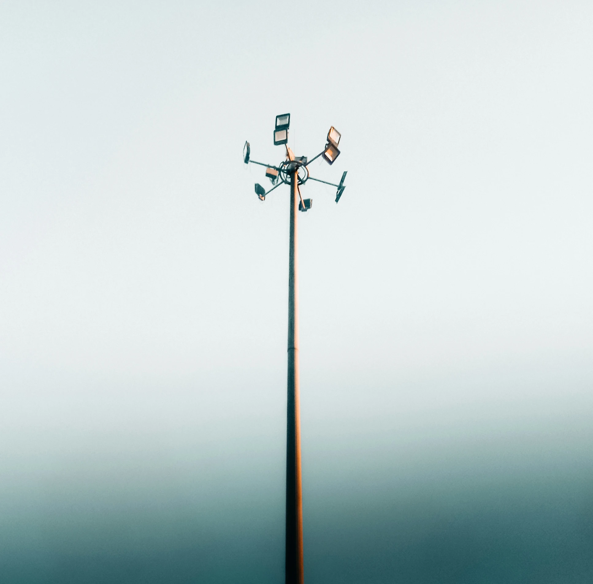 the top of the pole is covered in clocks