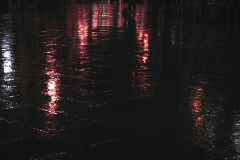 street lights reflected in water at night on a flooded street