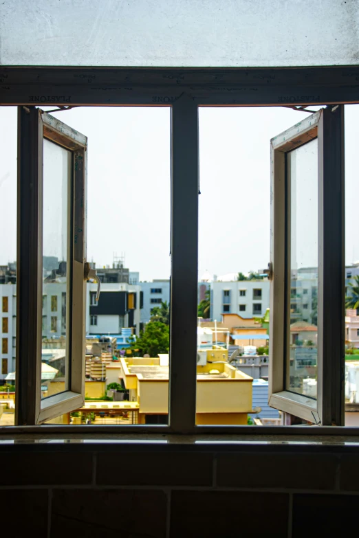 a open window looking out onto some buildings