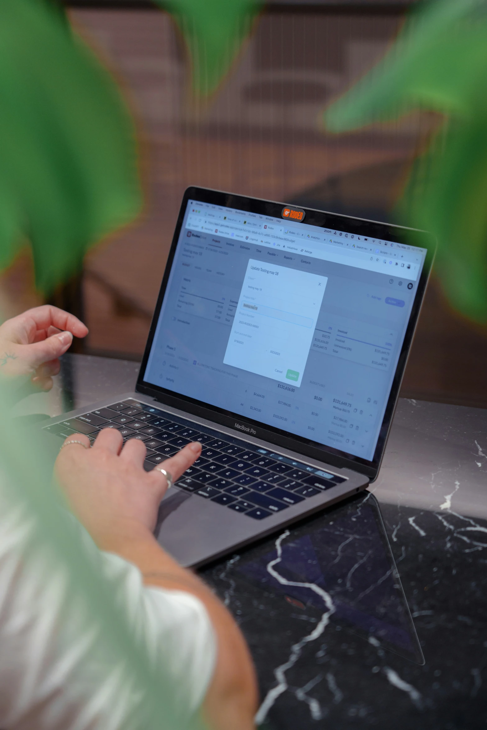 a person is working on a laptop on a desk