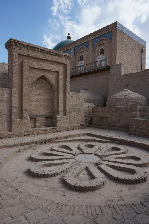 an intricately decorated stone courtyard with a sky background