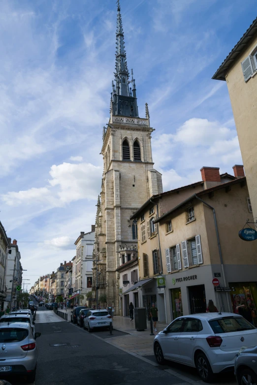 tall church tower towering over many city street