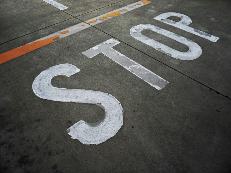 the top end of an airport runway with writing painted on it