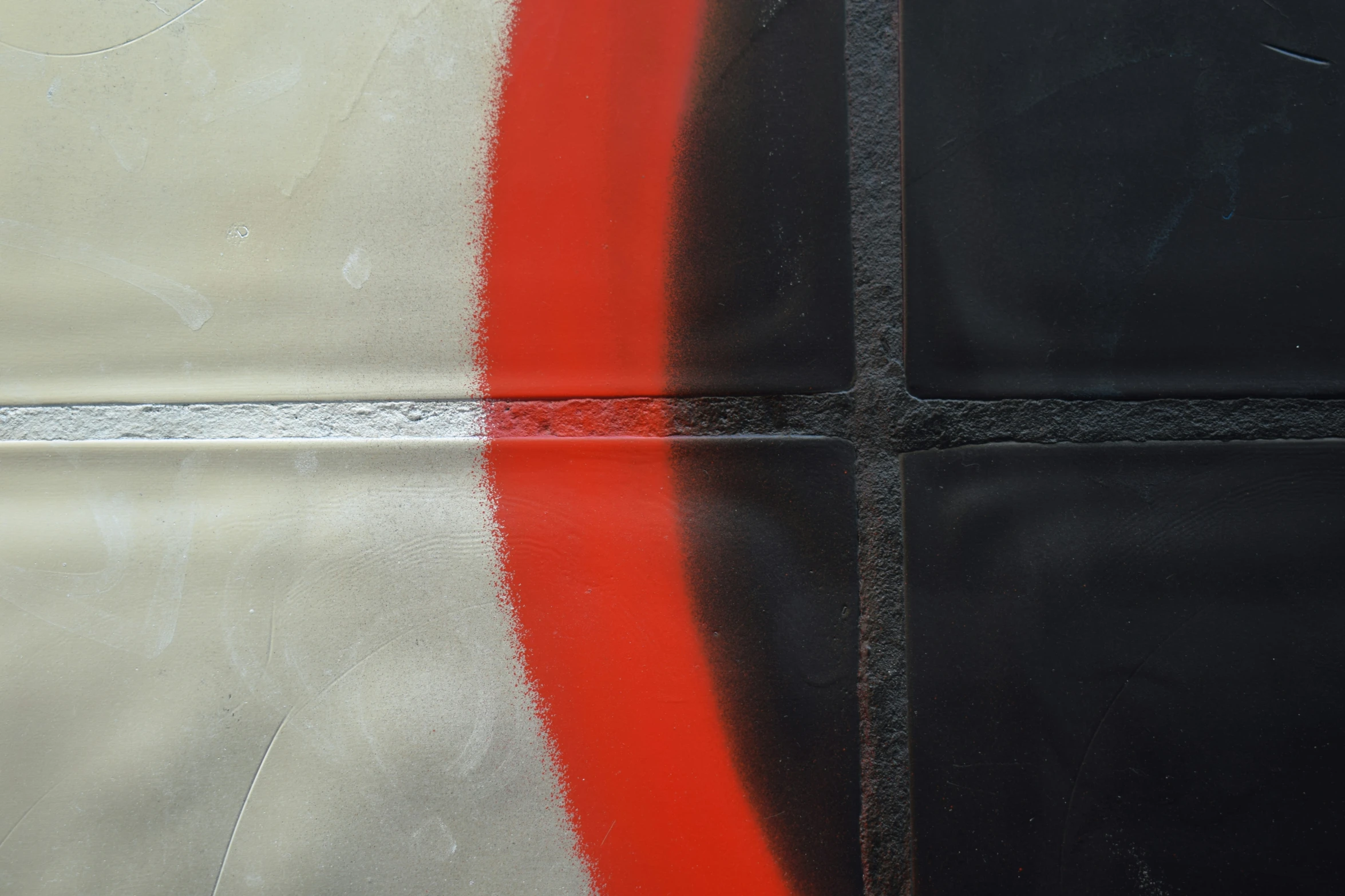 a piece of black and red graffiti on the side of a building