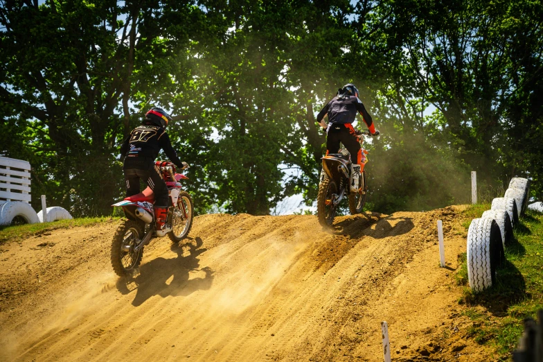 a dirt bike rider and a cyclist are racing together