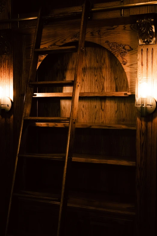 a wooden bunk with ladder and lights shining in dark room