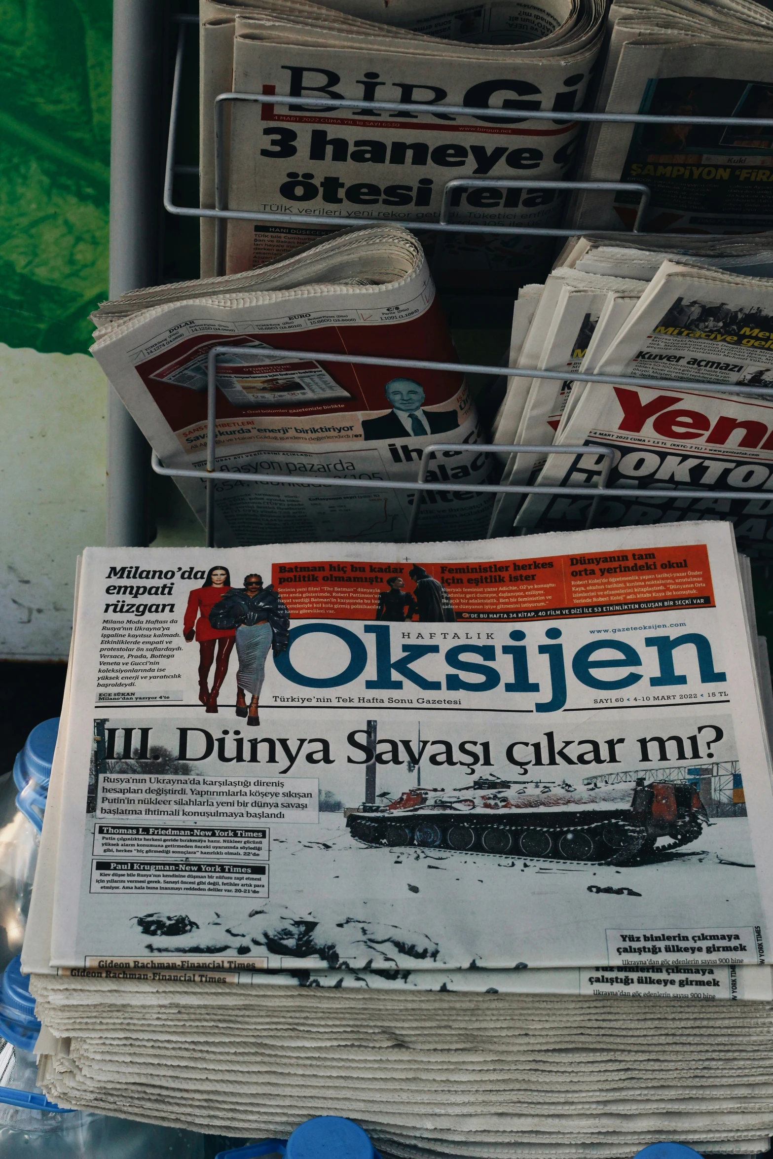 a pile of newspapers sitting on top of a table