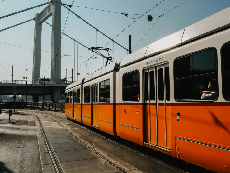 a white and orange train next to an empty dock