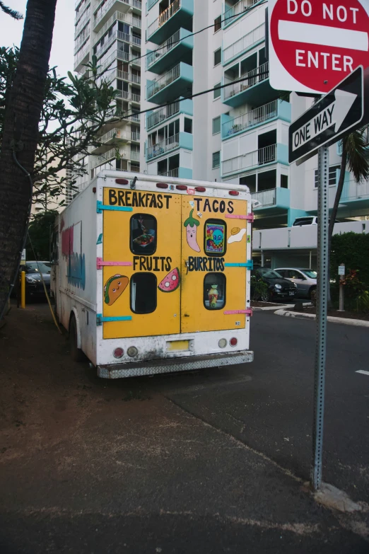 a food truck parked in front of a do not enter sign