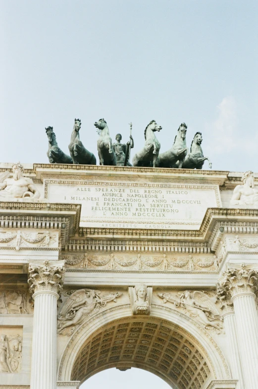 people are standing on a statue looking towards the sky