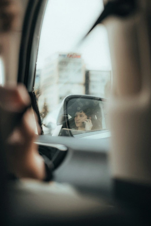 the view from inside of a vehicle as it sits near another vehicle