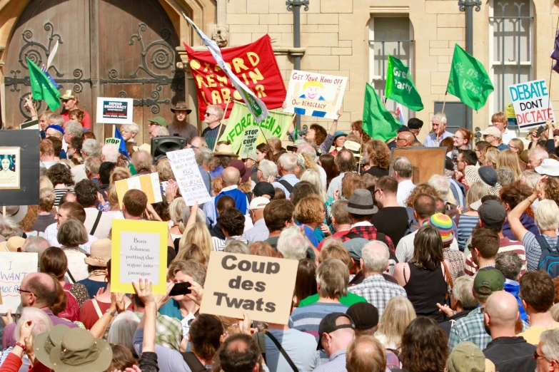 a crowd is gathered in a town for a political rally