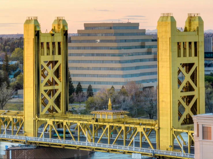 a large bridge over a river with tall buildings in the background