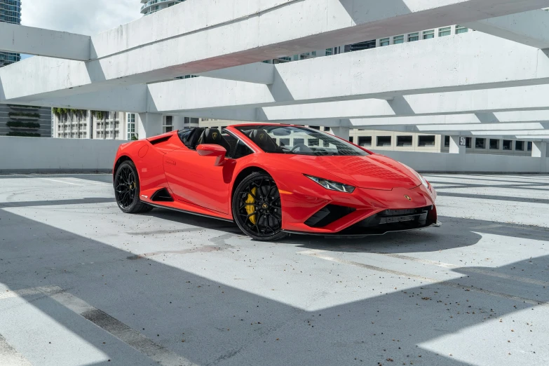 a red sports car parked in an empty lot