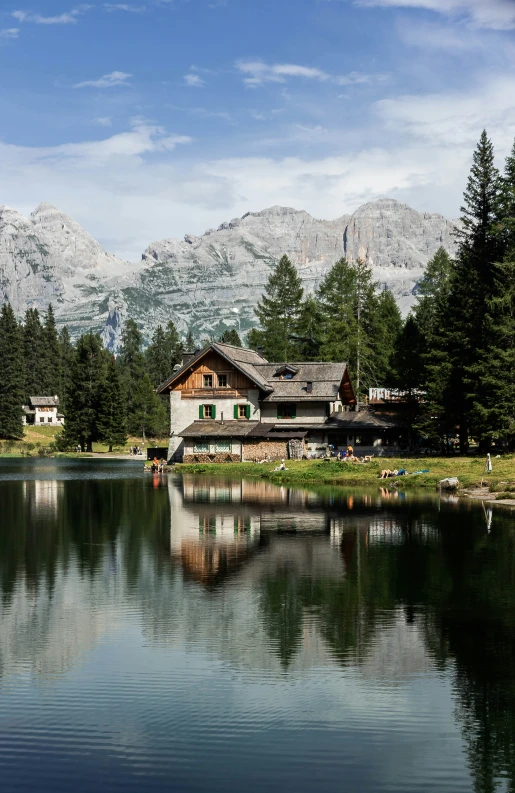 a large house is situated among trees by the water