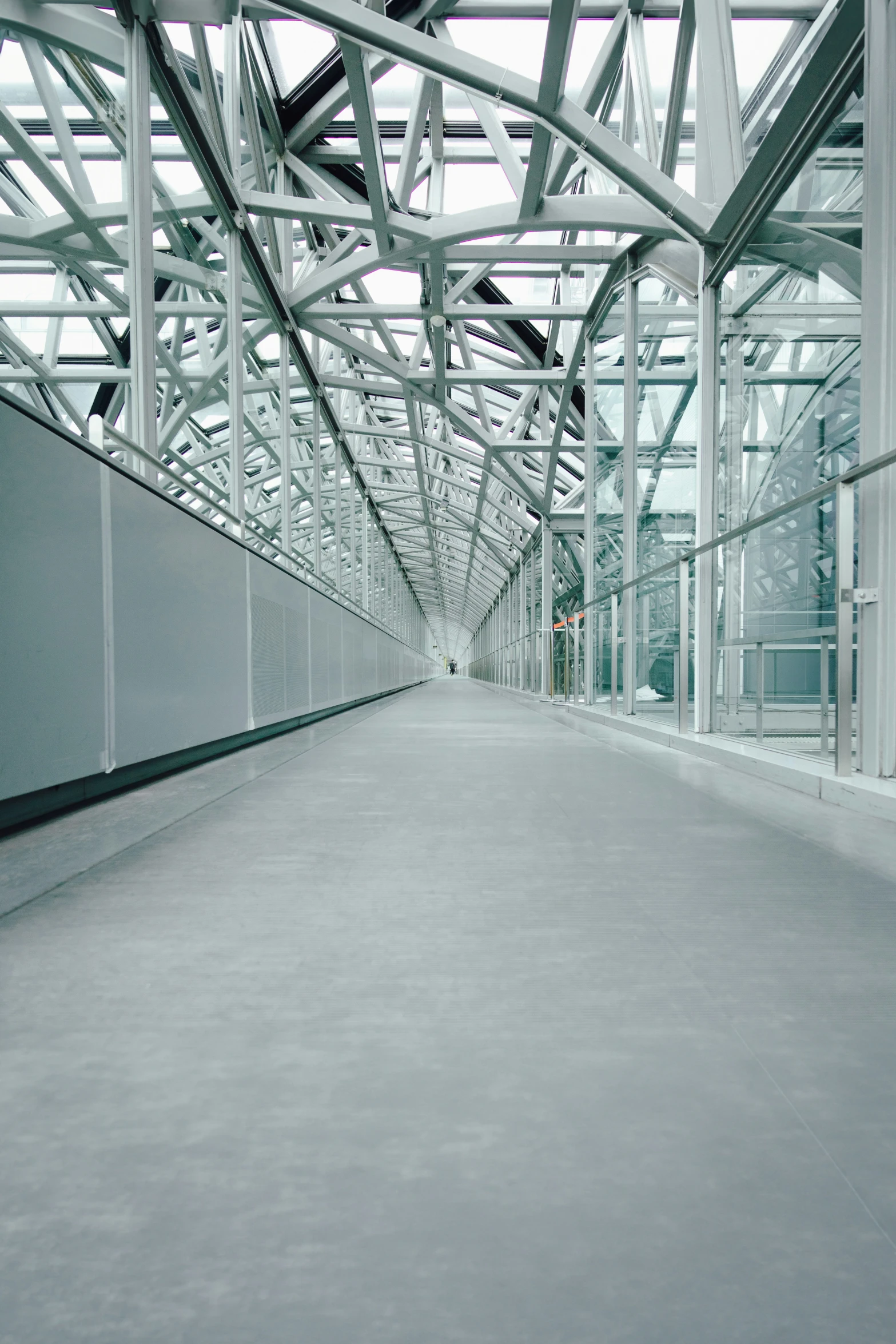 a walkway between two buildings with large windows