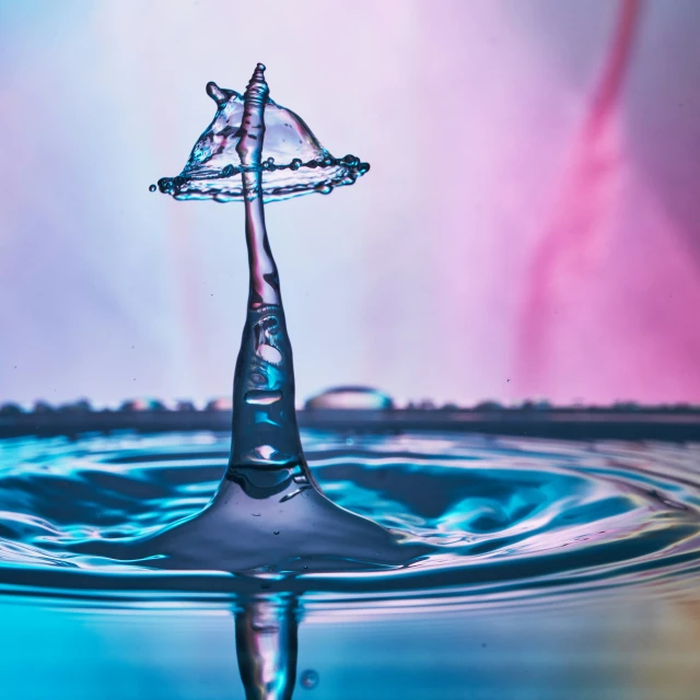 the large water drop is falling on a surface