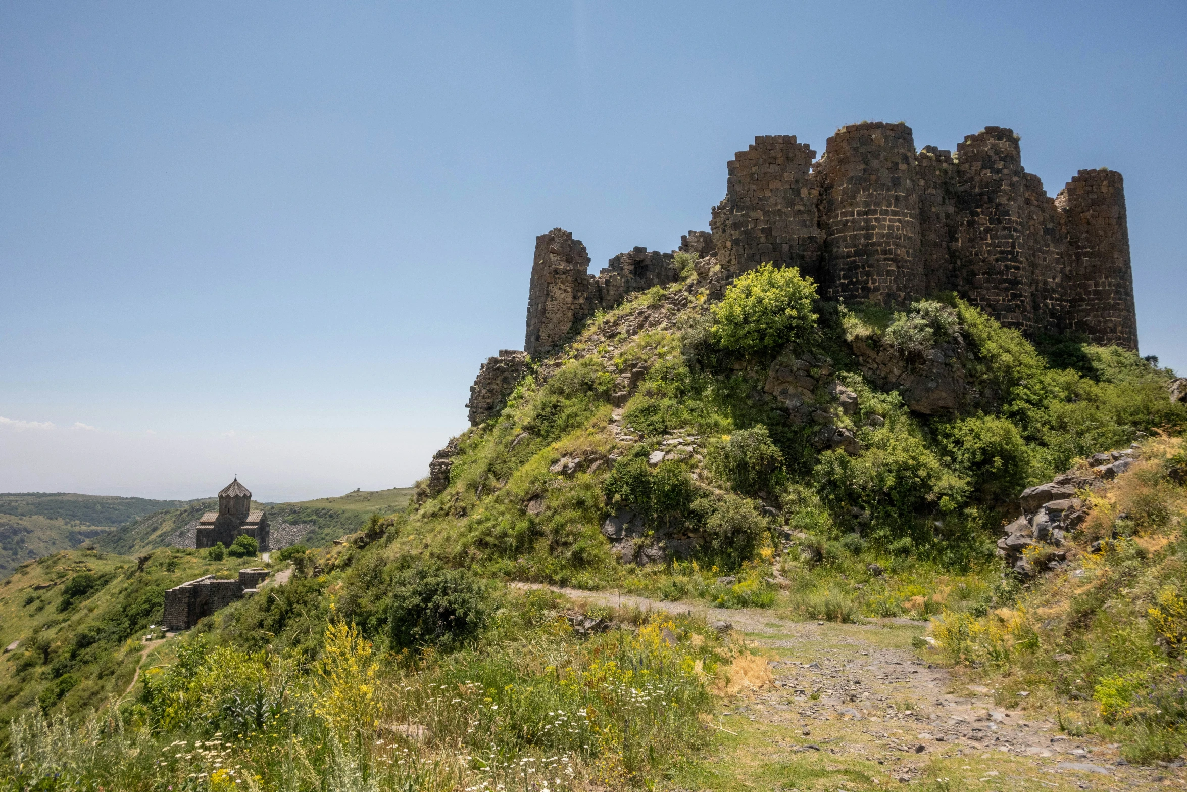 the ruins of an ancient castle on a hill