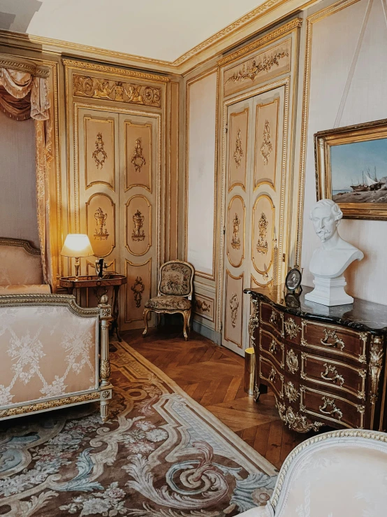 a fancy bedroom has gold trim and fancy furnishings