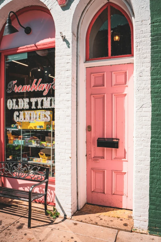 a large pink door on the side of a building