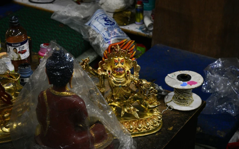 two figurines in gold and red are set near each other