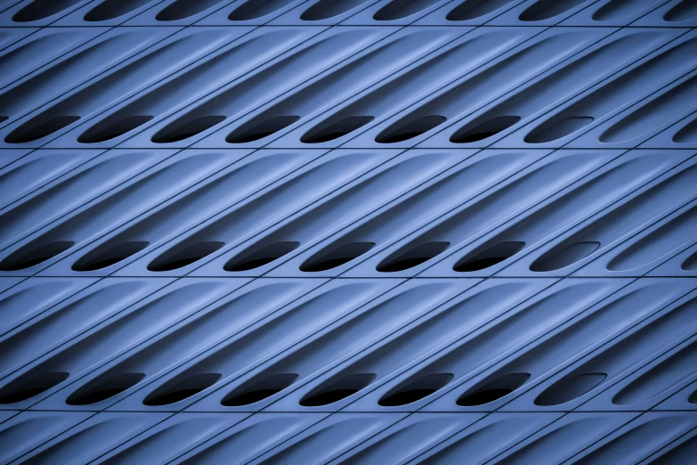 a pattern of dark - blue steel sheets with holes on them