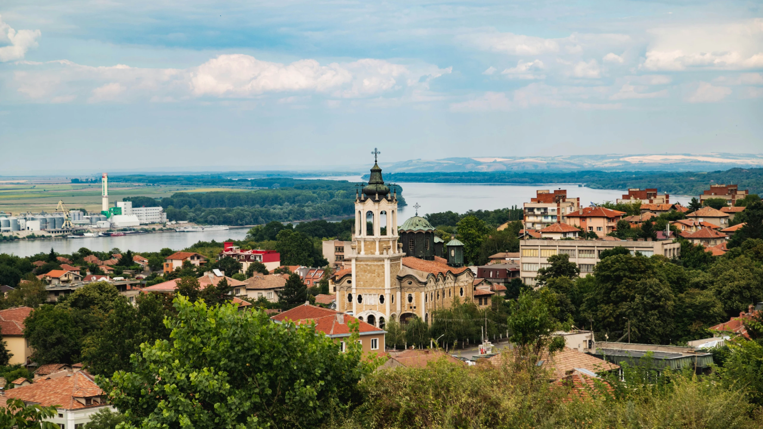 an old city is shown with water in the background