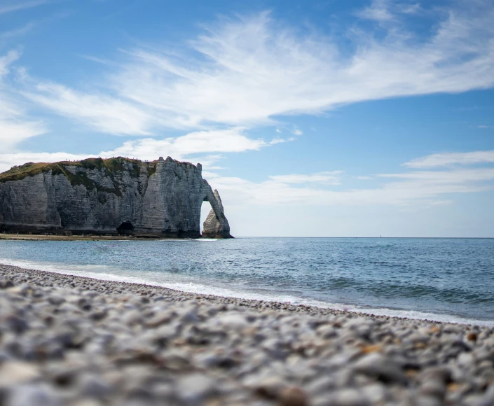 a small rock formation on the shore of an ocean