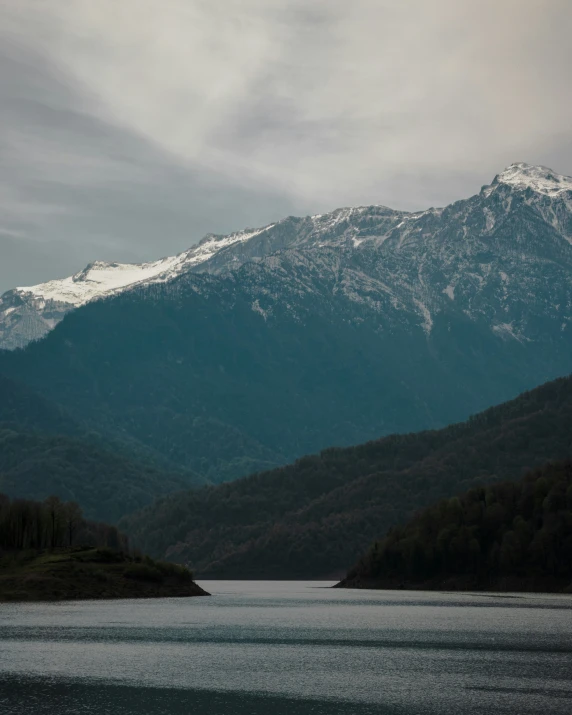 a mountain overlooks the water and mountains