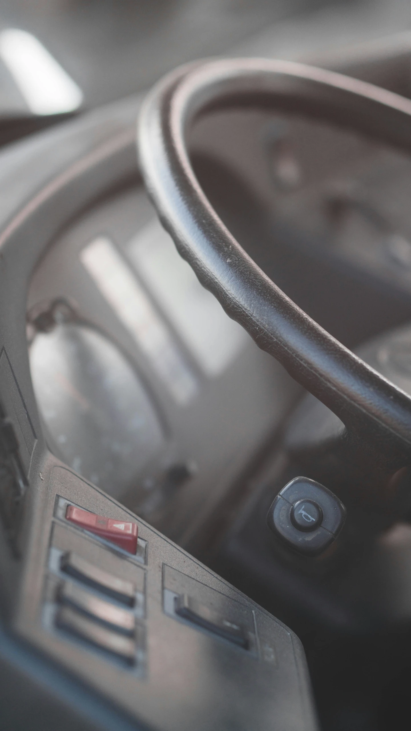 view from inside the driver's seat to steering wheel of a vehicle