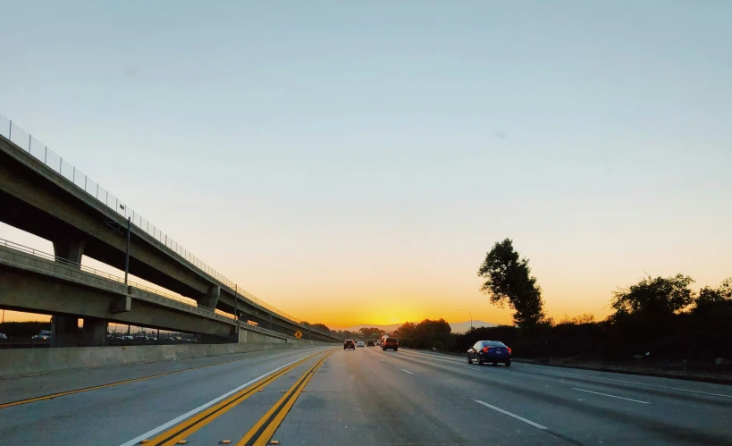 a very wide freeway with several traffic lights