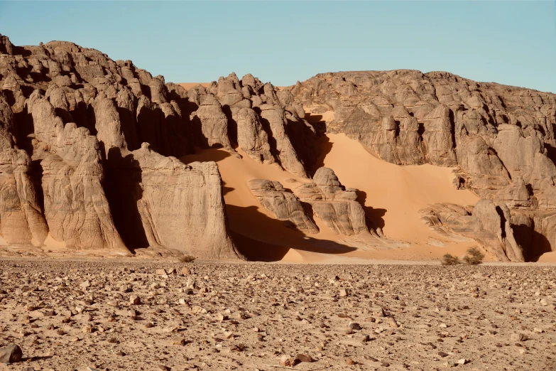 the landscape is made out of rock formations and sand dunes