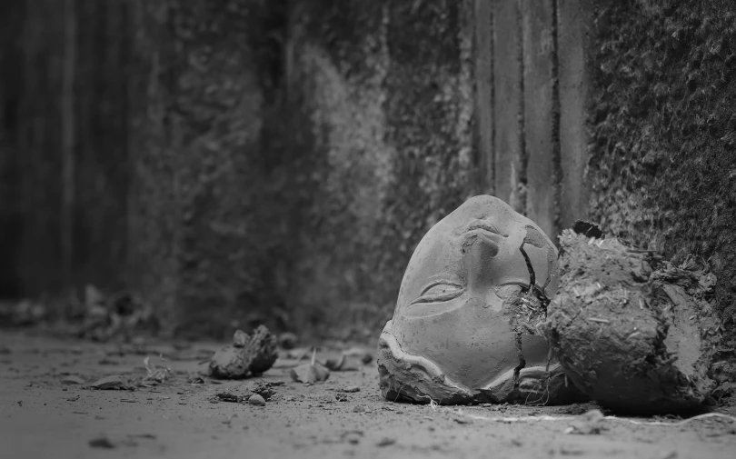 an image of a stone face laying next to wall