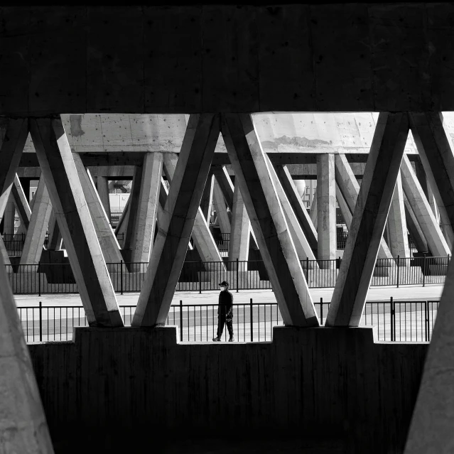 a bridge under a structure that is very tall